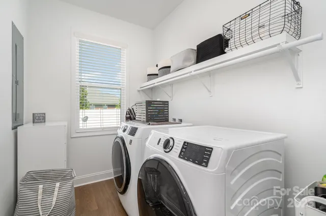 a view of washer and dryer with kitchen in the background