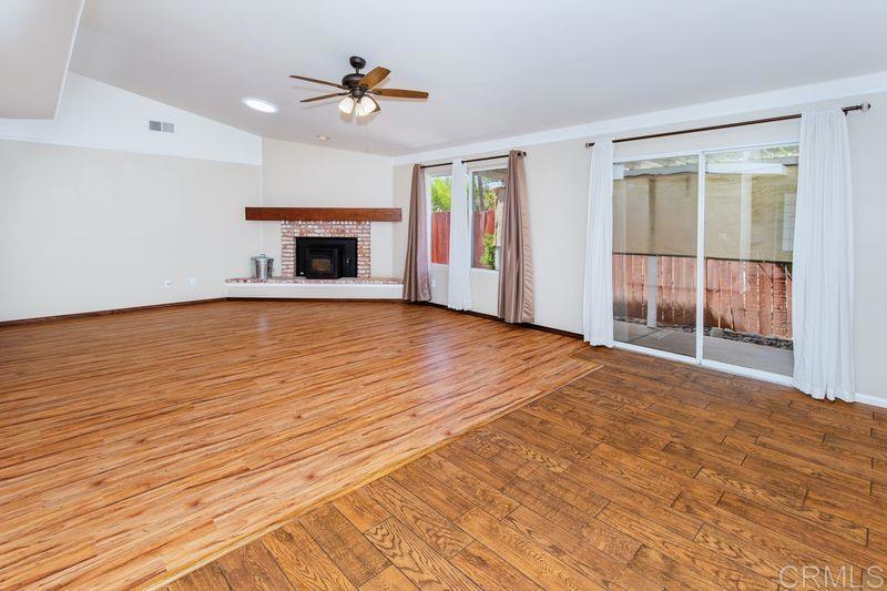 322 G Street Ramona, CA 92065 - Photo 11 of 61 a view of an empty room with a fireplace and a window