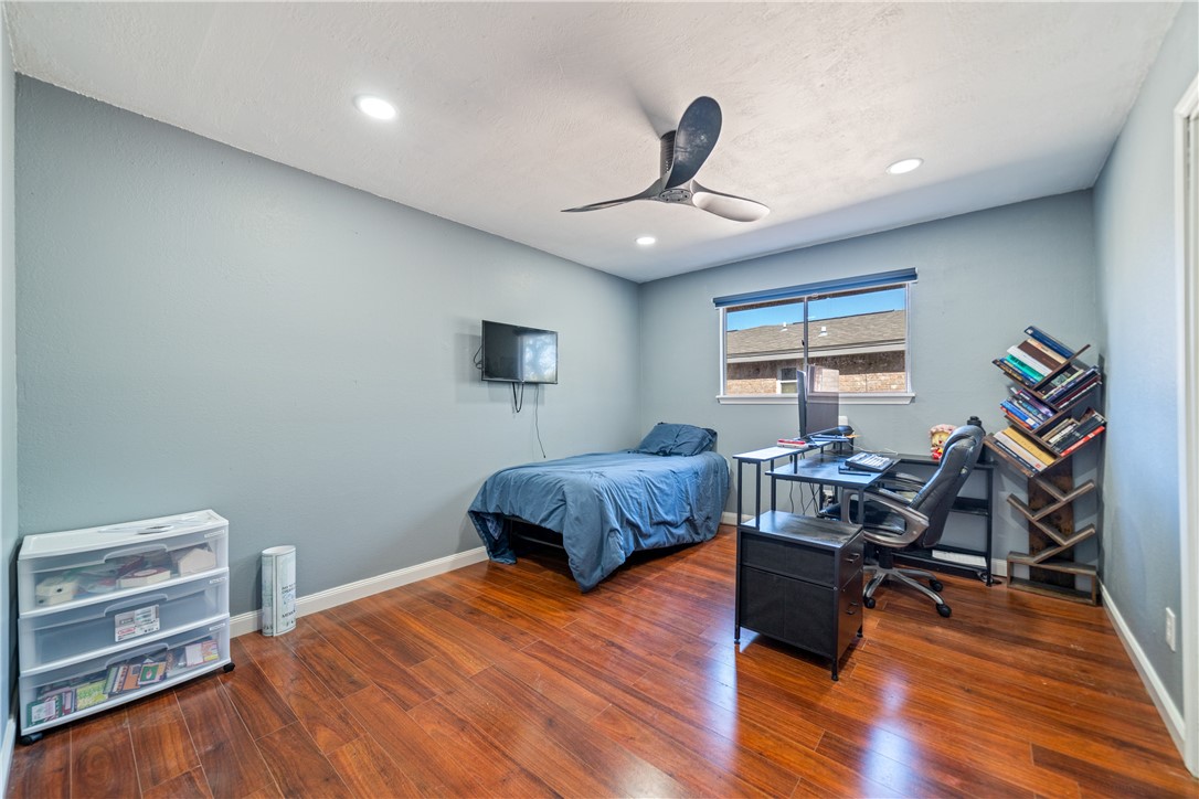 2217 Post Oak Drive Portland, TX 78374 - Photo 24 of 39 a bedroom with furniture and a wooden floor
