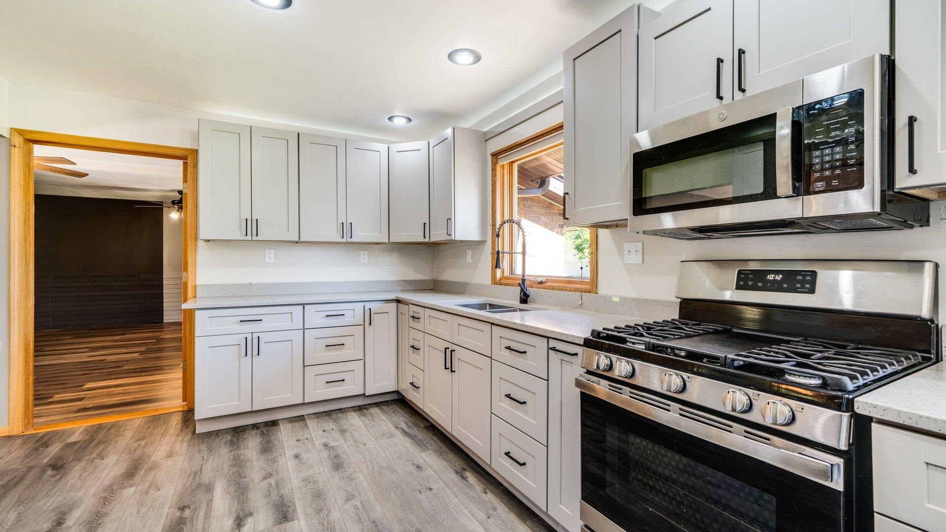 313 West Margaret Fuller Road Oregon, IL 61061 - Photo 6 of 46 a kitchen with stainless steel appliances granite countertop a stove and a microwave