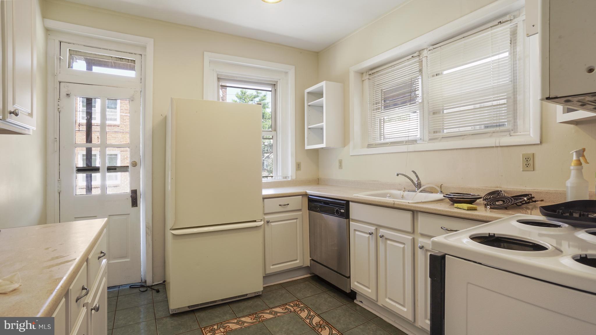 6214 Frederick Road Catonsville, MD 21228 - Photo 1 of 10 a kitchen with a sink stove and refrigerator