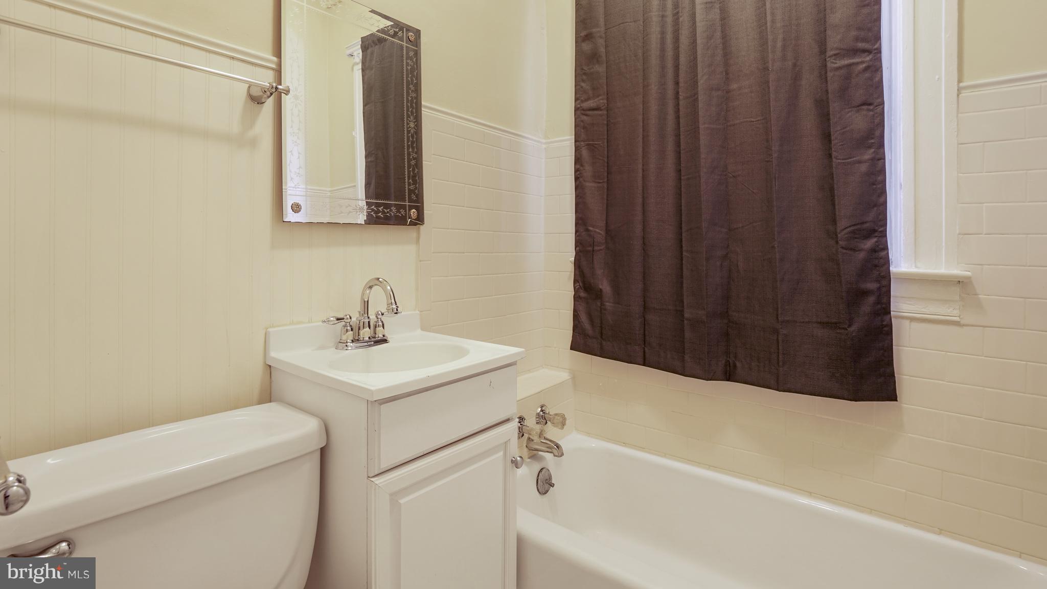6214 Frederick Road Catonsville, MD 21228 - Photo 8 of 10 a bathroom with a sink a toilet and shower