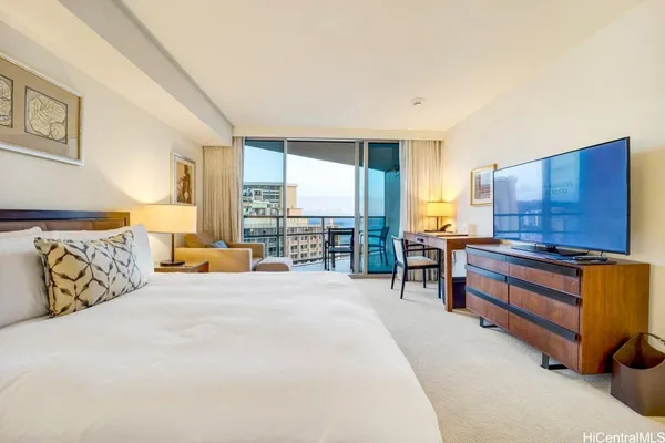 a large bedroom with a large bed and a larger window