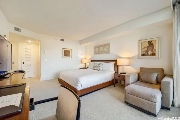 a bedroom with a bed and a couch