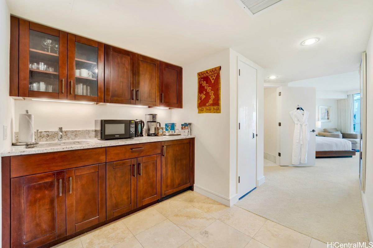 223 Saratoga Road, Unit 2006 Honolulu, HI 96815 - Photo 5 of 15 a kitchen with stainless steel appliances granite countertop a refrigerator and a sink