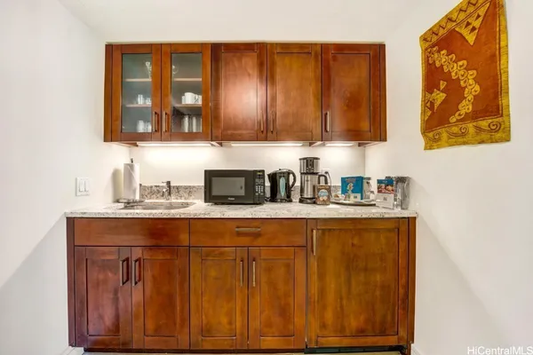 a kitchen with stainless steel appliances granite countertop wooden cabinets and a sink