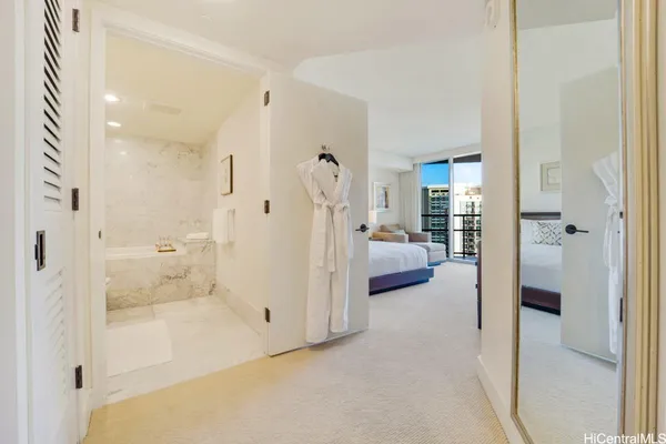 a en suite bathroom with a tub shower and bedroom view