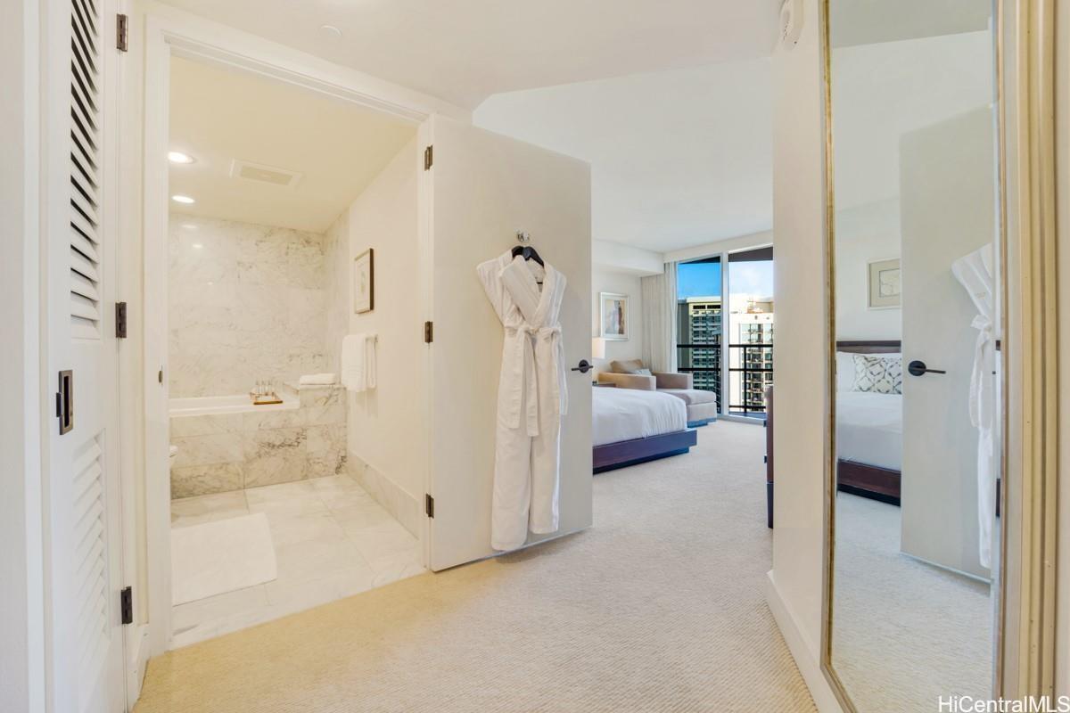 223 Saratoga Road, Unit 2006 Honolulu, HI 96815 - Photo 7 of 15 a en suite bathroom with a tub shower and bedroom view