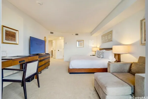a bedroom with furniture and a lamp