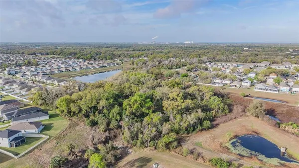 a view of a big yard with lots of green space