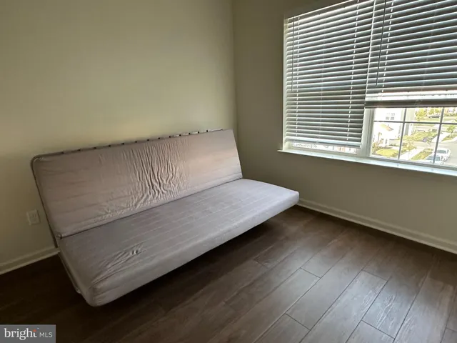 a view of room with window and wooden floor