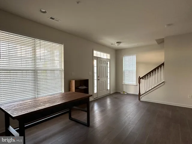 a room with wooden floor and windows