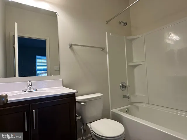 a bathroom with a sink toilet vanity and shower