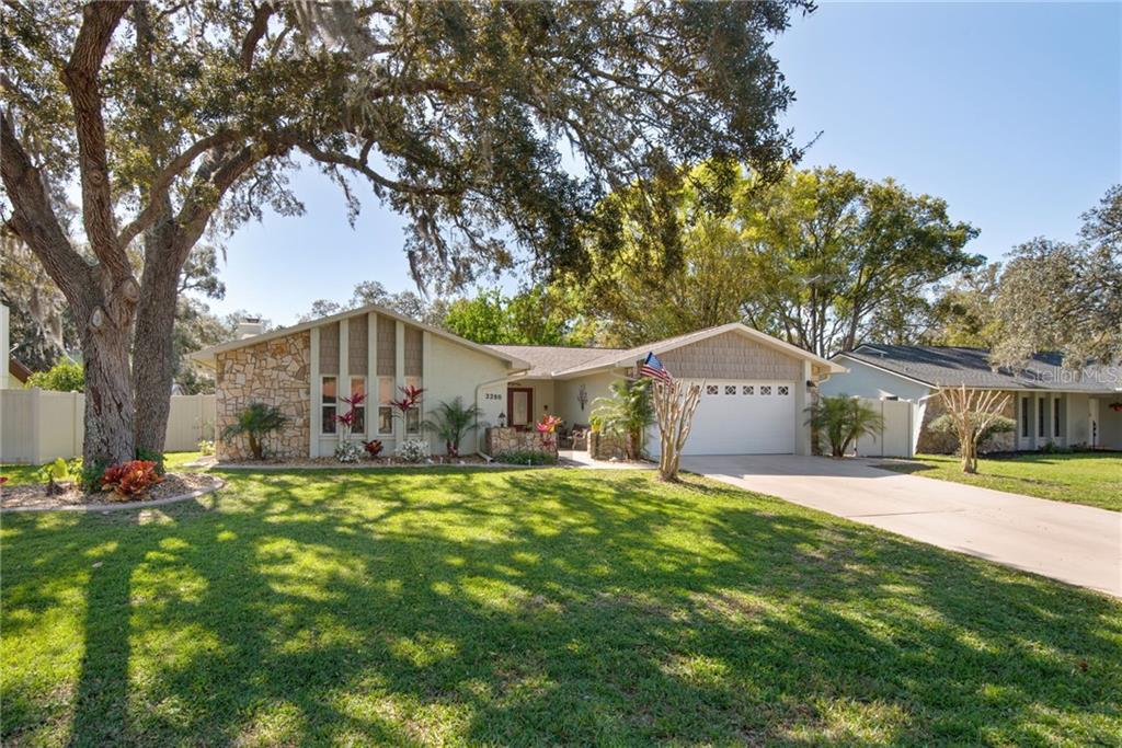 2280 Danforth Road Spring Hill, FL 34608 - Photo 1 of 1 a house view with a sitting space and garden