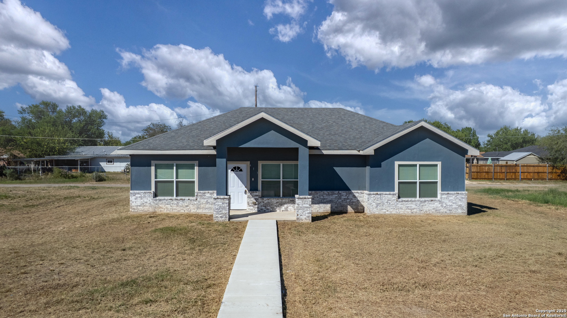 a front view of a house with yard patio and livingroom
