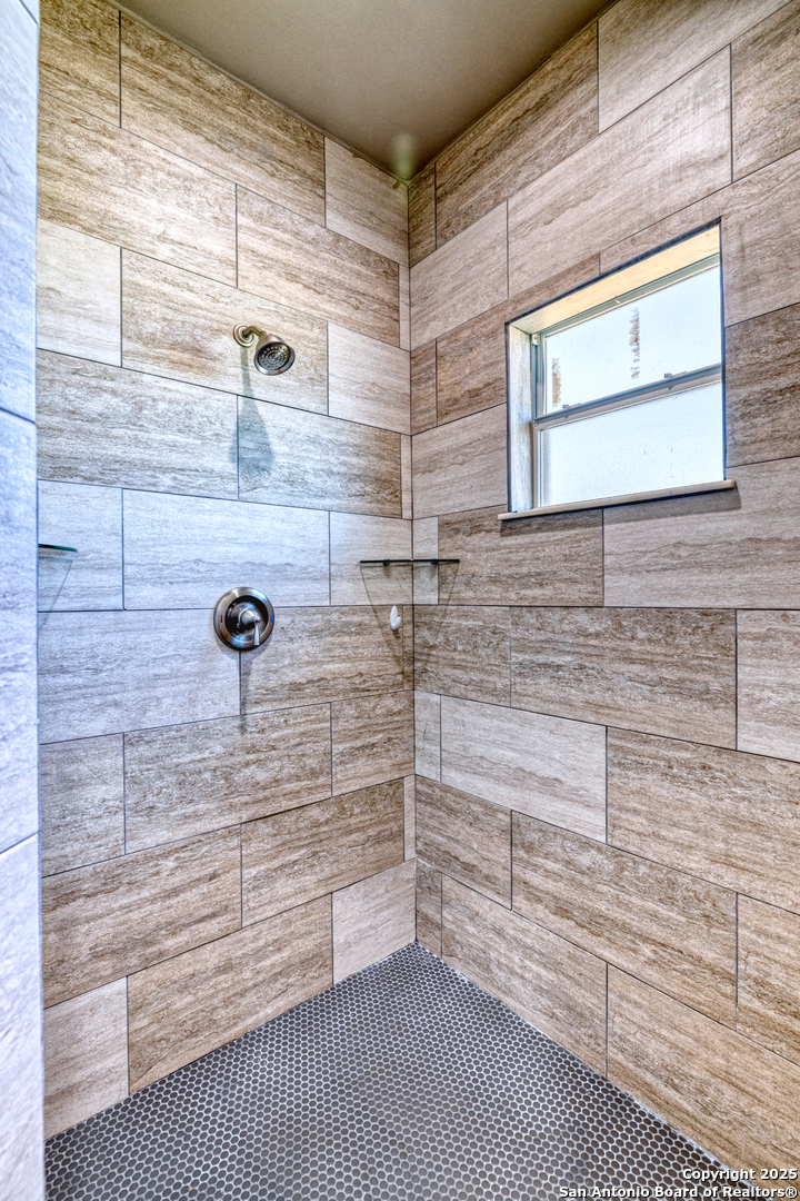 413 Guajillo Uvalde, TX 78801 - Photo 17 of 23 a bathroom with a shower