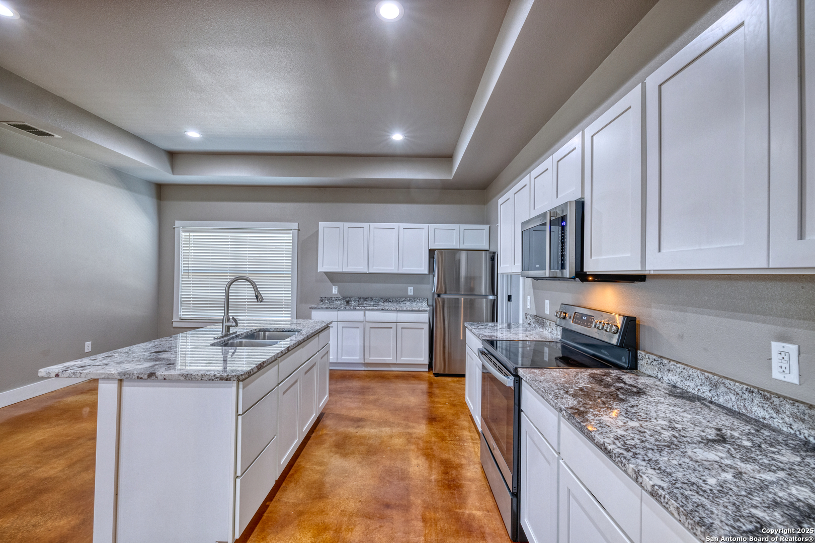 413 Guajillo Uvalde, TX 78801 - Photo 6 of 23 a large kitchen with stainless steel appliances granite countertop a sink stove and cabinets