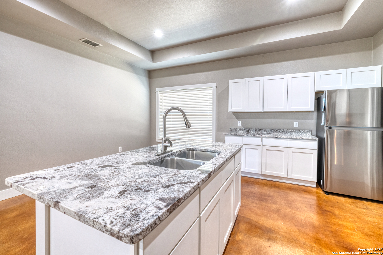 413 Guajillo Uvalde, TX 78801 - Photo 7 of 23 a kitchen with stainless steel appliances granite countertop a sink stove and refrigerator