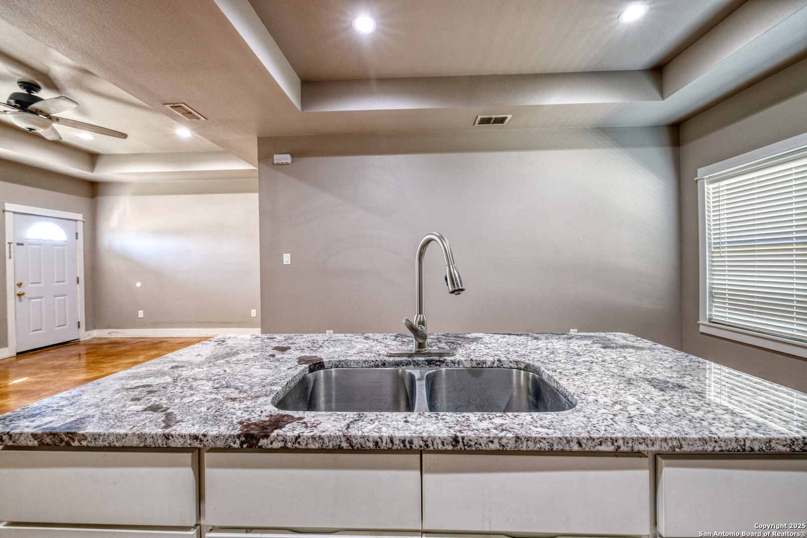 413 Guajillo Uvalde, TX 78801 - Photo 8 of 23 a bathroom with a granite countertop sink and a mirror