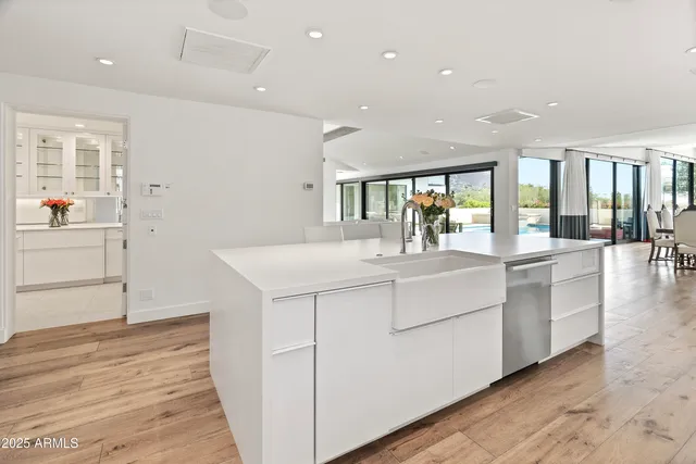 a large white kitchen with granite countertop a large white kitchen appliances and cabinets