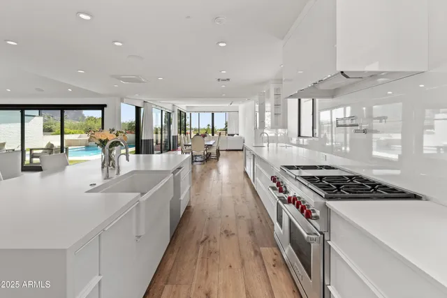 a kitchen with stainless steel appliances granite countertop a stove and a sink