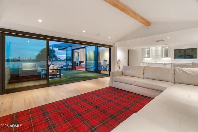 a living room filled with furniture and a floor to ceiling window