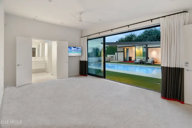 an empty room with closet and windows