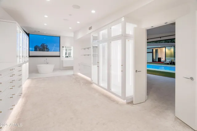 a view of a kitchen with a sink and large window