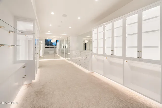 a view of a kitchen with refrigerator and wooden floor