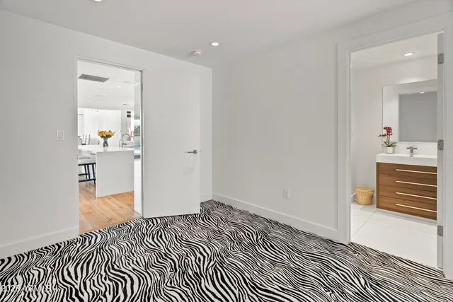 a bathroom with a shower sink vanity mirror and toilet