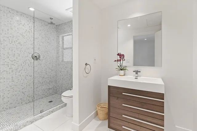 an empty room with closet and windows