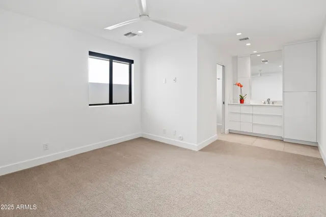 a bathroom with a sink vanity mirror and toilet