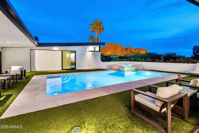 a room with pool table and a chandelier