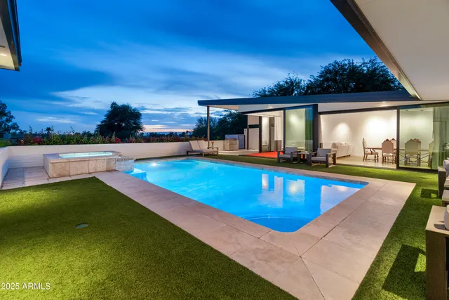 a living room with furniture pool table and a fireplace