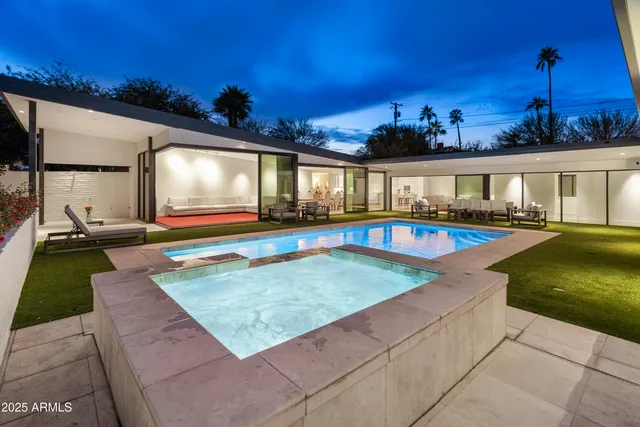 a view of a house with swimming pool and a yard