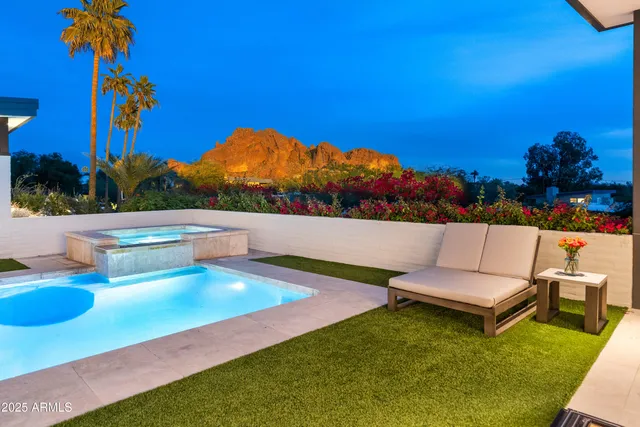 swimming pool view with a seating space