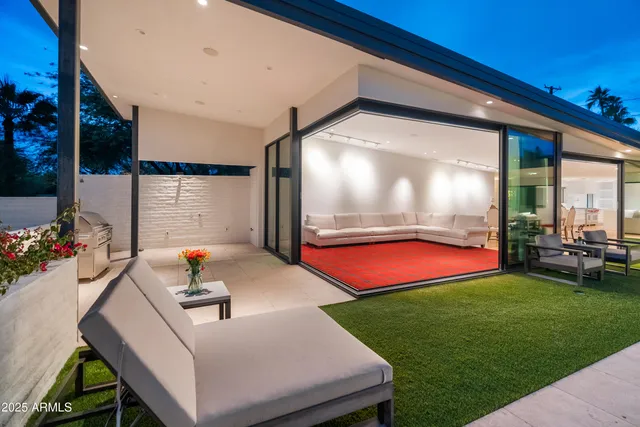 a room with pool table and large windows