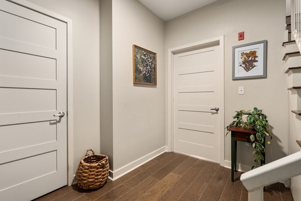 156-168 Terrace Street, Unit 402 Boston, MA 02120 - Photo 15 of 31 a room with chair and wooden floor