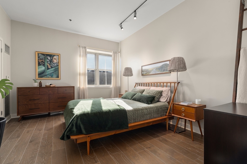 156-168 Terrace Street, Unit 402 Boston, MA 02120 - Photo 16 of 31 a bedroom with a bed and wooden floor