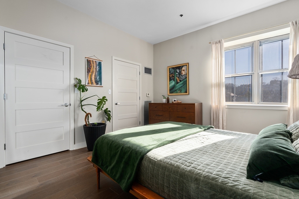156-168 Terrace Street, Unit 402 Boston, MA 02120 - Photo 18 of 31 a bedroom with a bed and a window