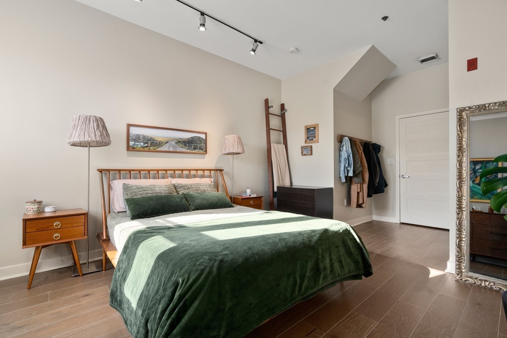 156-168 Terrace Street, Unit 402 Boston, MA 02120 - Photo 19 of 31 a bedroom with a bed and a potted plant