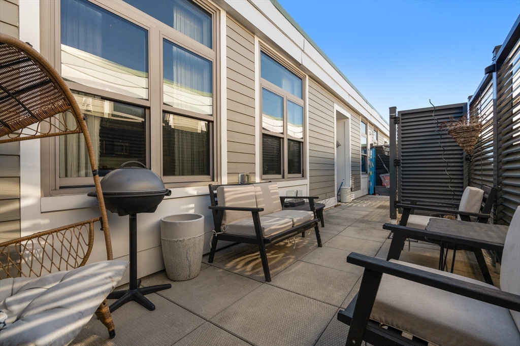 156-168 Terrace Street, Unit 402 Boston, MA 02120 - Photo 23 of 31 a front view of a house with outdoor seating