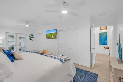 a bedroom with a bed and a painting on the wall