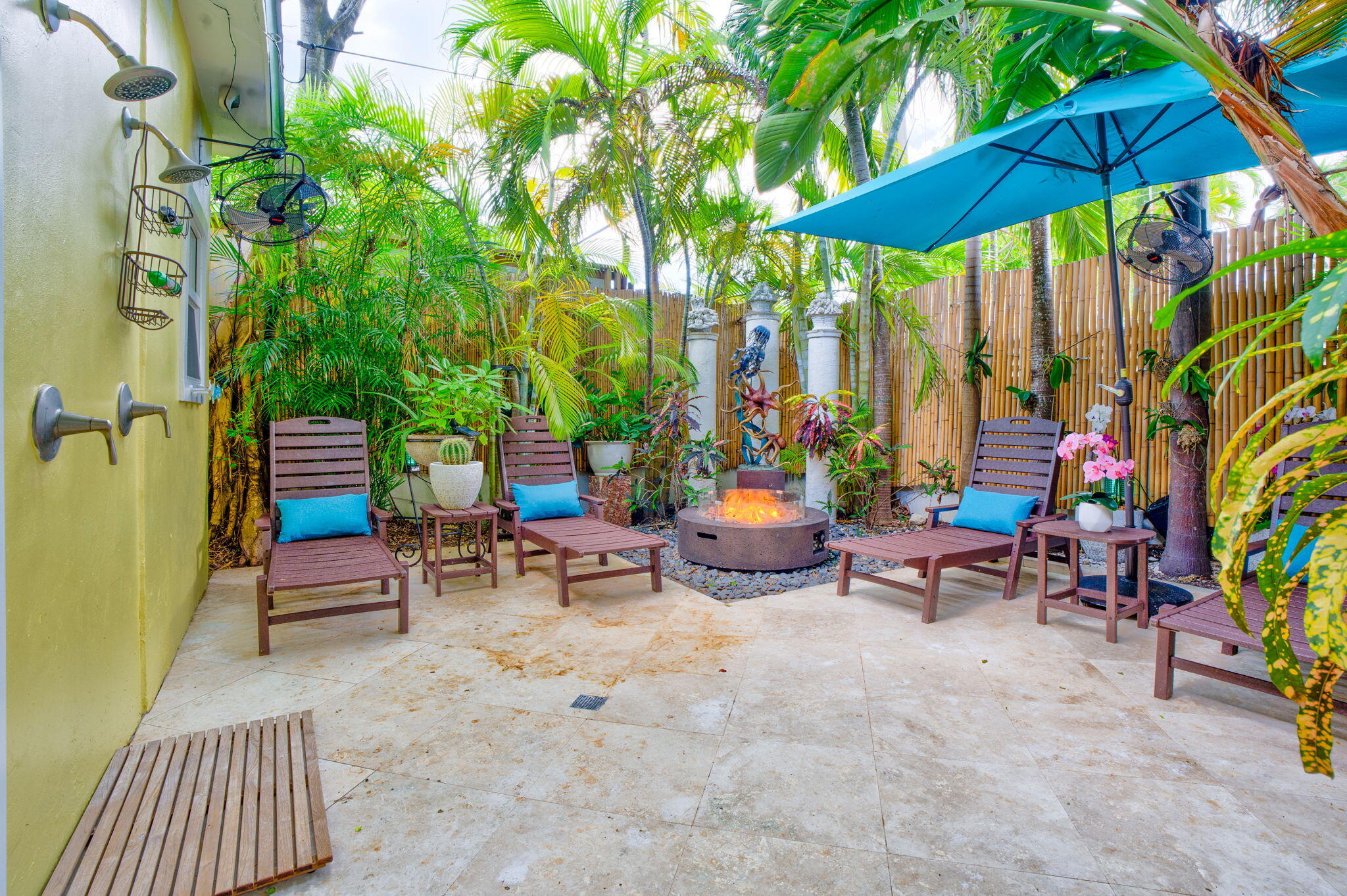 1501 White Street Key West, FL 33040 - Photo 36 of 49 an outdoor sitting area with chairs and table under an umbrella