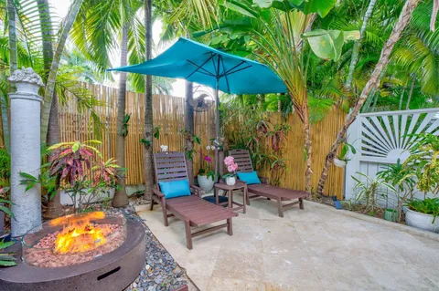 a view of a chairs and table in backyard