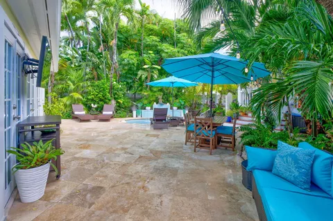 a view of a table and chairs under an umbrella in the patio