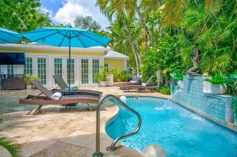 a view of a swimming pool with lounge chairs in patio