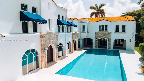 a view of a white house with garden