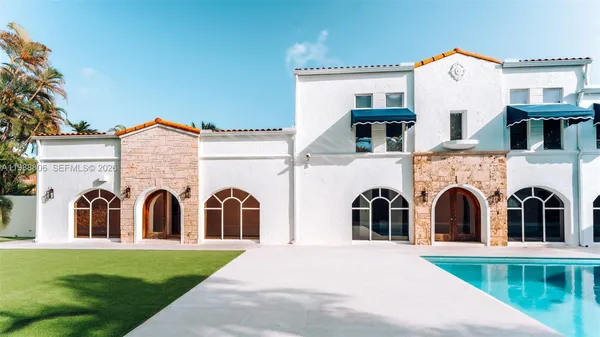 a view of swimming pool with a house in the background