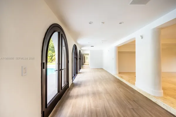 a view of staircase with white walls and white door